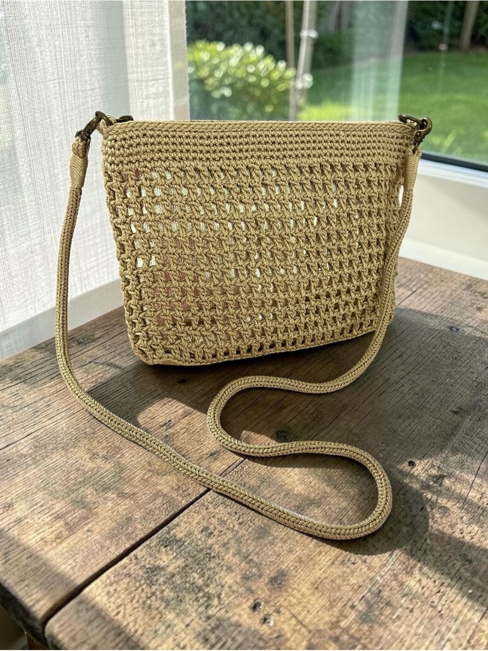 The SAK Crossbody Bag in Natural Tan with gold under the weaving.